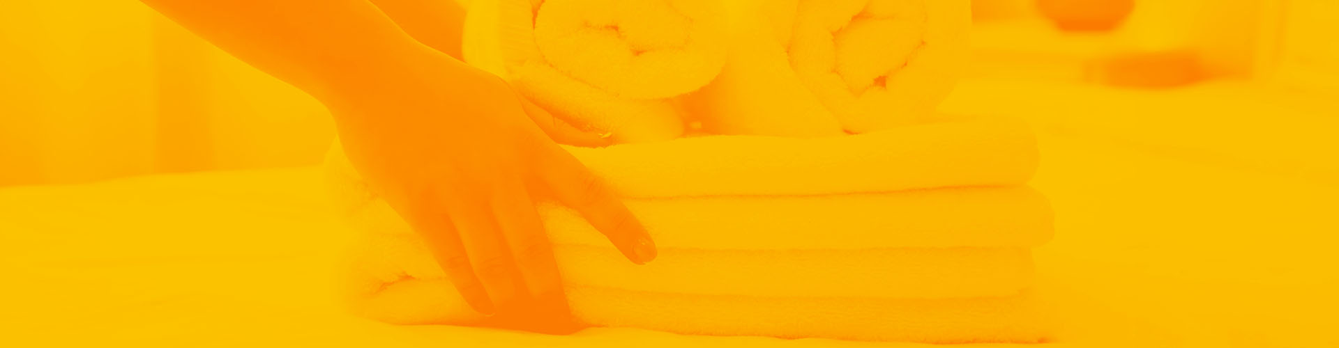 Stylized orange image of person holding stack of clean towels